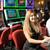 92207066-portrait-of-a-cute-caucasian-young-woman-playing-in-a-slot-machine-at-a-casino-and-smiling